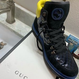 Men’s black, yellow , blue Gucci shoes.